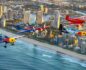 "High-flying aerobatic aircraft performing over the Gold Coast beach during the Pacific Airshow, with a crowd of spectators enjoying the show."